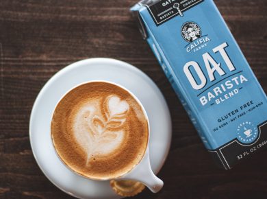 cup of latte beside oat barista box