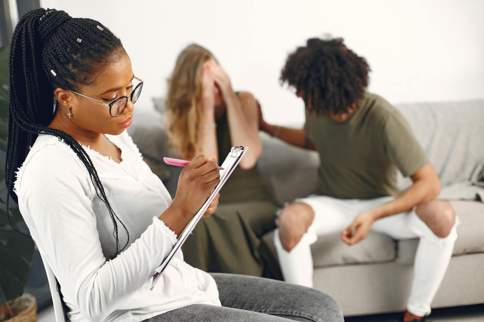 Consultant Observing a Couple While Taking Notes